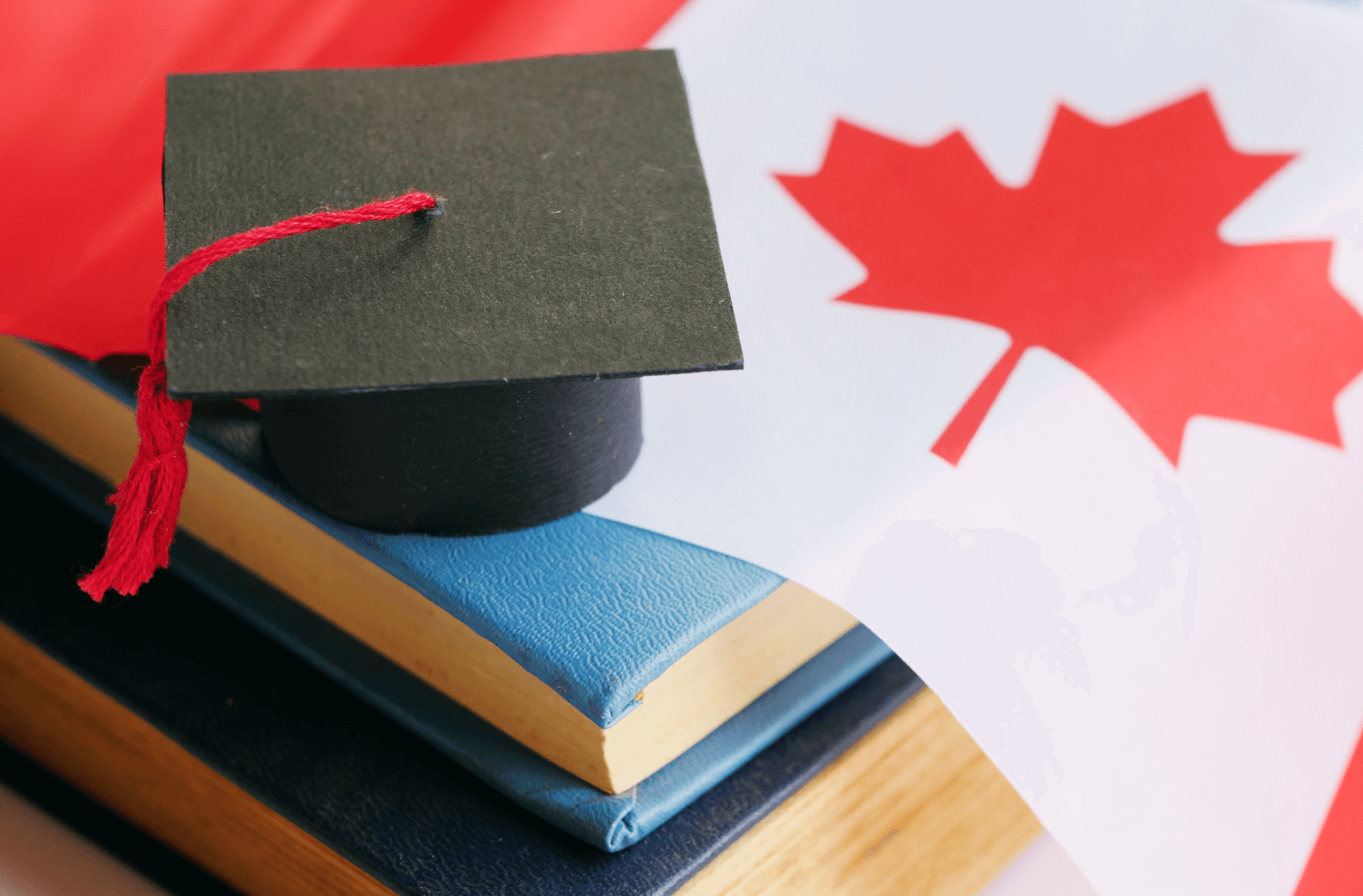 Student hat placed on the Canadian flag